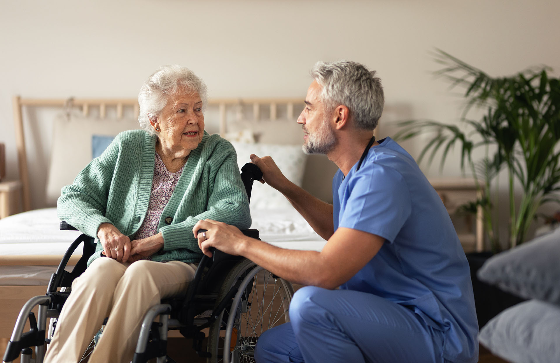 Care worker providing support and communication assistance to an older person